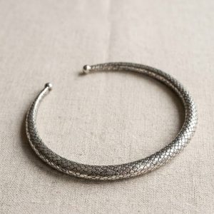 Modern minimalist silver choker jewelry product photography.