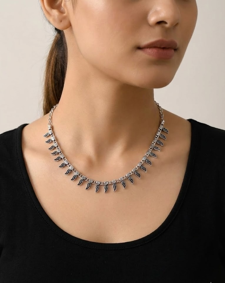 Traditional Indian silver jewelry styled with a silk saree for a festive look.