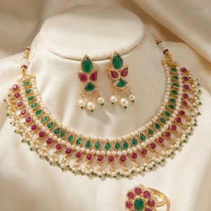 Gold plated kemp choker necklace set with pearls and matching ring on display bust